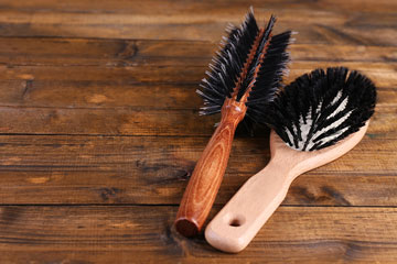 hair brushes on a wooden background
